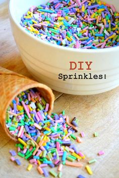 sprinkles spilling out of an ice cream cone into a bowl on a wooden table