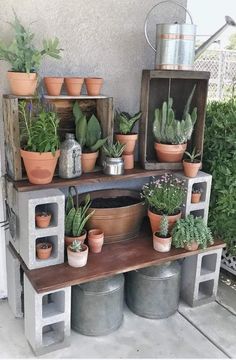 an outdoor plant stand with potted plants on it