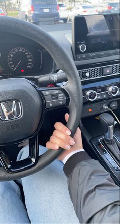 a man driving a car with his hands on the steering wheel