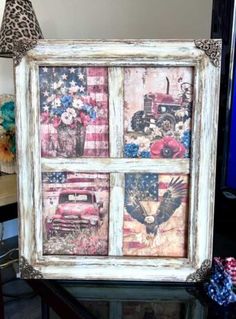 an old window decorated with american flags and trucks is displayed in front of a television