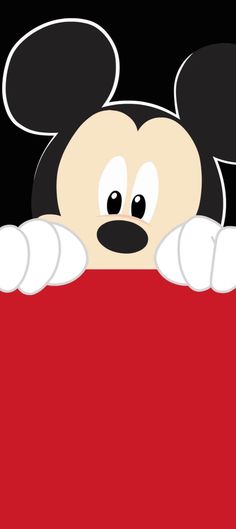 mickey mouse peeking out from behind a red sign with his hands on the back of it