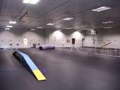 an empty gym with blue and yellow mats