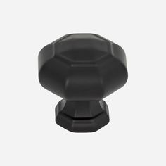 a black knob on a white background