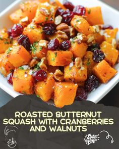 roasted butternut squash with cranberries and walnuts in a white square bowl