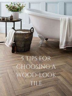 a bath tub sitting next to a wooden floor