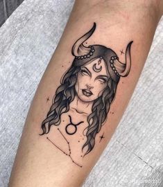 a woman with horns on her head has a zodiac sign tattooed on her arm and the word