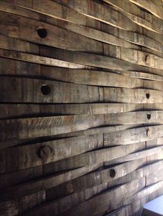 a wall made out of wooden planks with holes in the middle and one hole at the top