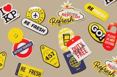 many different stickers are shown on the ground with words and symbols in yellow, red, white and blue