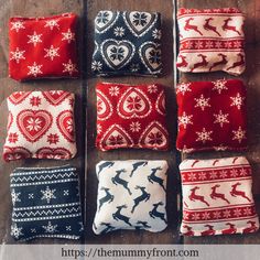 six different christmas pillows sitting on top of a wooden table with text overlaying them