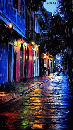 an image of a rainy street scene with people walking in the rain and lights on