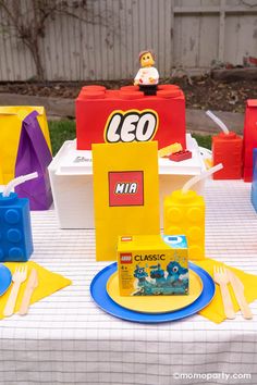 the table is set up with legos and plastic bags for children's birthday party