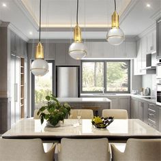 a dining room table with chairs and lights hanging from it's ceiling in a kitchen