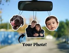 a couple and their dog are hanging from a car's rearview mirror with the caption your photo