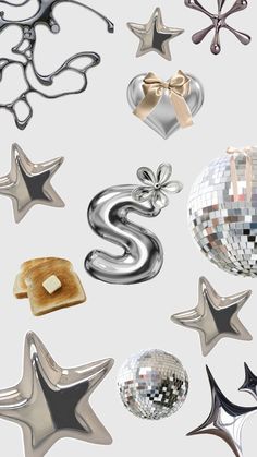 many shiny objects are grouped together on a white background with silver stars and other decorations