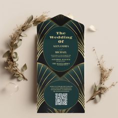 an art deco styled wedding card with gold and green details on the front, along with greenery