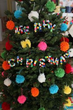 a small christmas tree decorated with pom poms