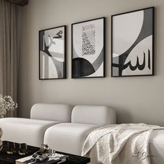 a living room filled with white furniture and paintings