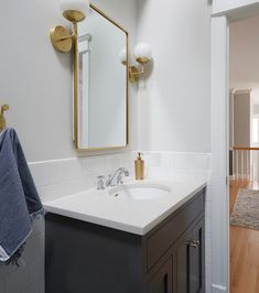 Bathroom Remodel with Gold Mirror and Gold Sconces