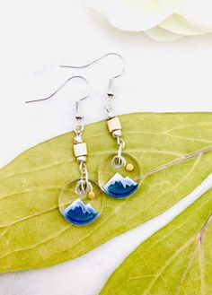 the earrings are made with glass and wood