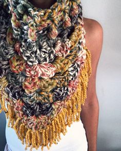 a woman is wearing a multicolored scarf