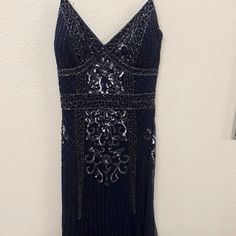 This Dress Us A Dark Navy Blue Color And Full Of Bead And Measures 57 Inches From Top To Bottom. Elegant Sequin Dress With Beaded Straps For Formal Occasions, Elegant Formal Sequin Dress With Beaded Straps, Blue Party Dress With Beaded Straps, Blue Beaded Dress For Night Out, Blue Beaded Formal Dress, Formal Blue Beaded Dress, Elegant Blue Sleeveless Sequin Dress, Blue Embellished Cocktail Evening Dress, Blue Beaded Cocktail Dress