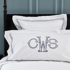 a black and white monogrammed bed with two pillows