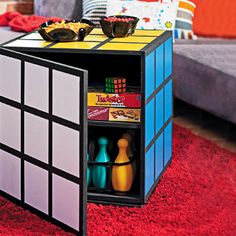 a rubik cube coffee table is shown in this living room setting with red carpet