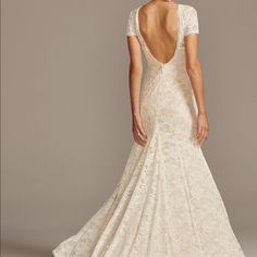 a woman in a wedding dress is looking back