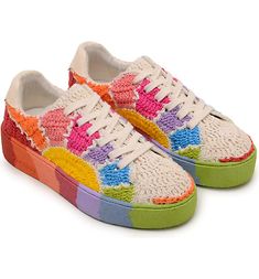 a pair of shoes with multicolored laces on the bottom and soles