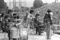 the rolling stones performing on stage in front of an audience at a rock and roll festival