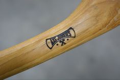 a close up view of a wooden handlebar with the word'x'engraved on it