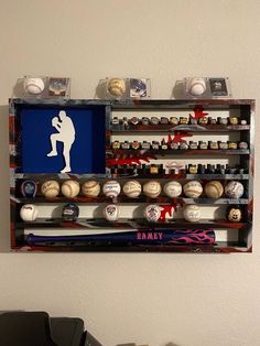 a display case with baseballs, bats and other sports memorabilia on it's wall