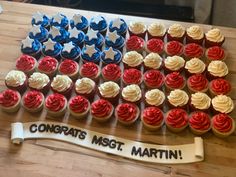 cupcakes with red, white and blue frosting are arranged in the shape of an american flag