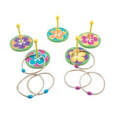 three colorful flower shaped objects with ropes and beads on top of each other, all in different colors