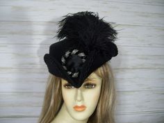 "Black woolen tricorn hat with black trim, black ostrich feathers and a beautiful black/silver seed bead buckle accent. Very pretty hat. This hat is a little over 22.5\" for the inside circumference but also has a built in tie hat sizer but if you would like a peel and stick style hat sizer just let me know. I ship Priority mail. I ship many times a week. If you need your item quicker let me know your zip code and I can figure shipping rates for you. Please let me know if you have any questions Vintage Brimmed Costume Accessories, Vintage Black Hat For Costume Party, Victorian Brimmed Costume Hats And Headpieces, Victorian Brimmed Costume Hat, Vintage Black High Crown Costume Accessories, Black Brimmed Mini Hats For Costumes, Brimmed Black Mini Hats For Costumes, Victorian Style Adjustable Black Costume Hat, Vintage Black Costume Hats And Headpieces For Carnival