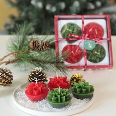 small christmas decorations on a plate with pine cones