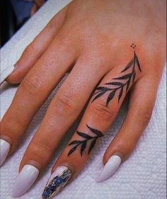 a woman's hand with a tattoo on it