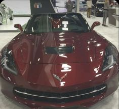 the front end of a red sports car