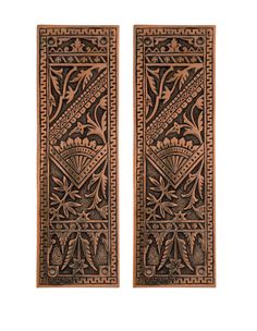 two wooden plaques with designs on them