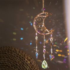 a close up of a wind chime hanging from a ceiling with lights in the background