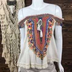 World Market Swing Tent Blouse. 2 Way Wear; Off Shoulder Or Scoop Neckline. Tassel Tie Front. Smocked Top Hemline. Fringe Trim Hem. Bohemian Design. Material: 100% Rayon (Lace): 100% Cotton Approximate Measurements Length Shoulder To Hem: 20 In. Pit To Pit: 18 In. Condition: Nwt. New With Tags. No Trades/Holdsalways Open To Reasonable Offers, Send Them Before Someone Else Does!!Bundle 2 Or More Items To Save More! Casual Multicolor Blouse With Boho Collar, White Bohemian Off-shoulder Blouse, Summer Festival Beige Blouse, Beige Summer Festival Blouse, White Casual Top With Boho Collar, Cream Bohemian Blouse For Vacation, White Casual Tops With Boho Collar, Bohemian Cream Blouse For Vacation, Multicolor Sleeveless Smocked Top For Vacation