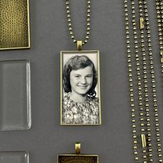 an old photo is hanging on a necklace next to some other items that have been placed around it