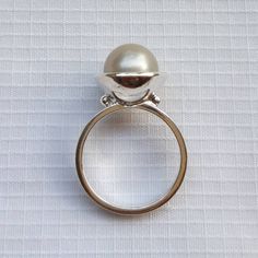 Minimalist South Sea Pearl engagement ring in silver tones Sterling silver pearl ring A romantic gift for engagement, anniversary and birthday Handmade and designed by Barock Pearl Pearl: shape round, color silver, size 9 mm South Sea Pearl cultured/grown at Lombok Island, Indonesia Ring size: please select the size from the chart For orders more than 250 $ US FREE SHIPPING. Shipping with EMS Parcel, approx. 10 to 15 working days. Don't forget to leave your phone number to complete the address Modern Sterling Silver Dome Ring For Wedding, Modern Pearl Rings For Anniversary, Elegant Sterling Silver Dome Ring For Anniversary, Elegant Sterling Silver Dome Ring Gift, Modern Pearl Wedding Ring, Modern Round Pearl Rings, Minimalist Pearl Rings For Formal Occasions, Minimalist Formal Round Pearl Ring, Formal Minimalist Round Pearl Ring