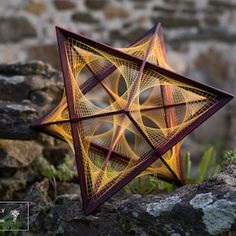 an artistic object sitting on top of a rock