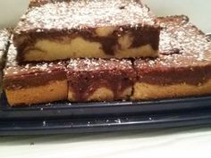 several pieces of cake sitting on top of a blue plate covered in powdered sugar