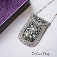 Introducing our Metal Mobile Shape Mini Handbag, a stylish fusion of elegance and functionality. Adorned with intricate mosaic work and gracefully curved around the bag, this accessory exudes a unique vintage charm. The beautiful silver chain adds a touch of sophistication, making it not just a handbag but a statement piece. Designed for modern living, this mini handbag is perfect for carrying essentials with style. Its compact size ensures convenience on the go, while the exquisite craftsmanshi Luxury Mobile Phone Clutch Pouch, Silver Pouch Clutch For Travel, Luxury Crossbody Pouch As Gift, Luxury Crossbody Pouch For Gift, Luxury Rectangular Mobile Phone Evening Bag, Luxury Mobile Phone Evening Bag, Luxury Square Pouch As Gift, Elegant Square Phone Bag For Travel, Elegant Square Portable Phone Bag