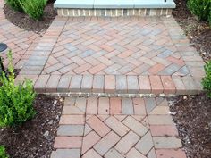 a bench sitting on top of a brick walkway