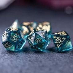 four blue and gold dice sitting on top of a table