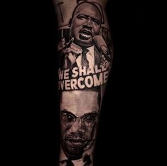 a man's leg with an image of two men and the words we shall overcome