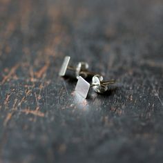 These simple, geometric studs in sterling silver are perfect for everyday wear. The silver diamond shapes have a brilliant, mirror finish and are backed by sterling silver posts that are soldered in place. Each pair comes with sterling silver wingnut backs. The diamond shapes measure approximately 8mm from point to point. Minimalist Silver Diamond-shaped Jewelry, Silver Earrings With Diamond Markers As Gift, Minimalist Sterling Silver Diamond-shaped Earrings, Minimalist Sterling Silver Diamond Cut Earrings, Minimalist Diamond-shaped Earrings For Gift, Modern Silver Earrings, Necklace Top, Photo Locket Necklace, Geometric Studs